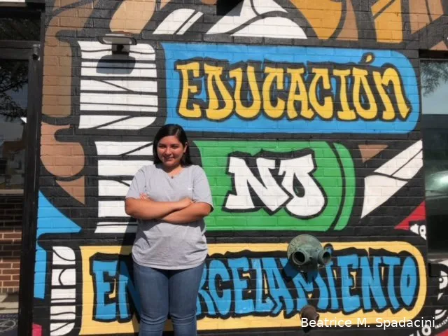 Woman standing in front of a mural