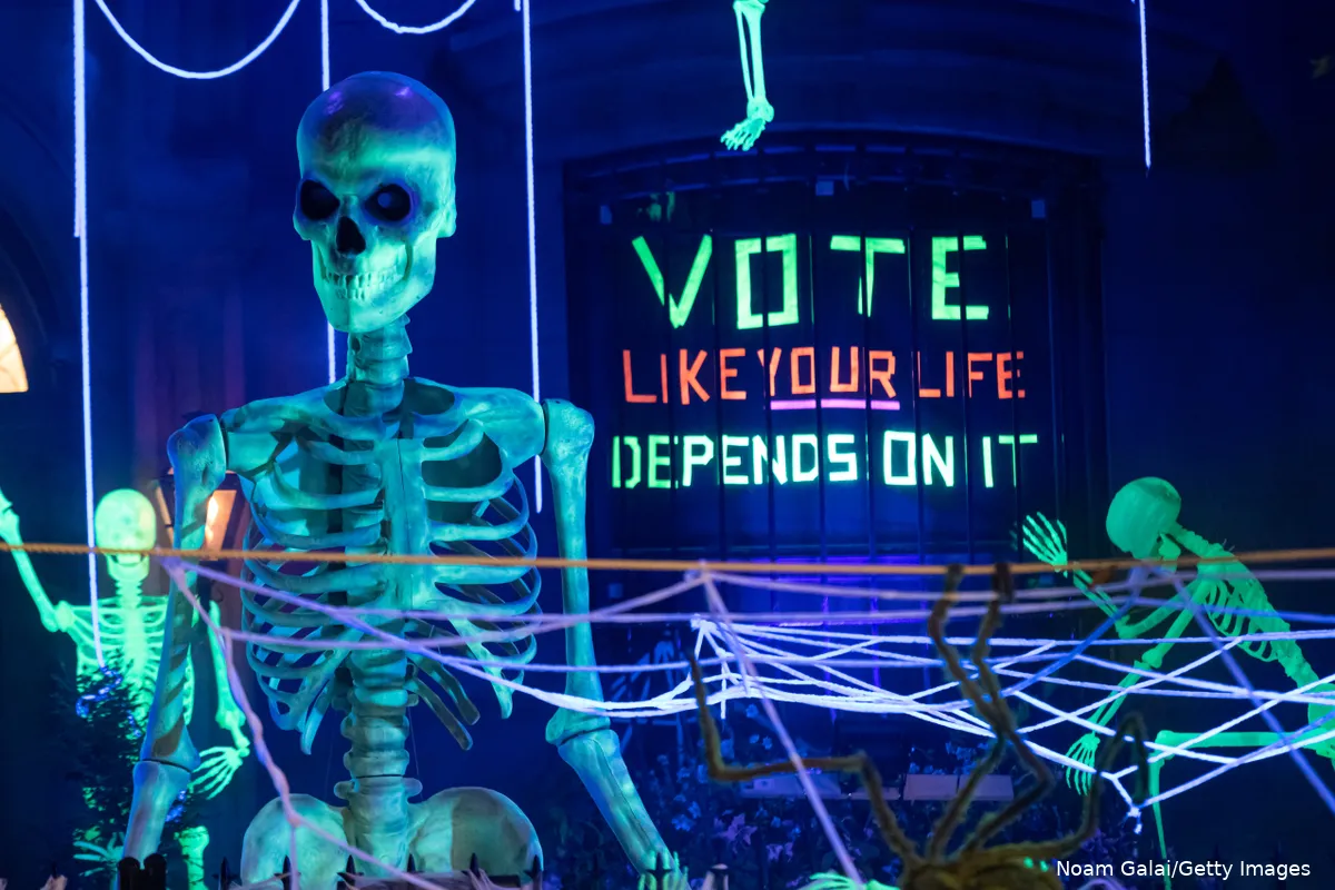 Halloween decorations with a sign that reads "Vote like your life depends on it"
