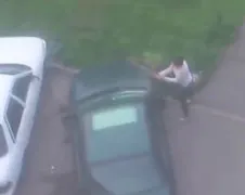 Vrouw knuppelt voorraam van auto aan gort