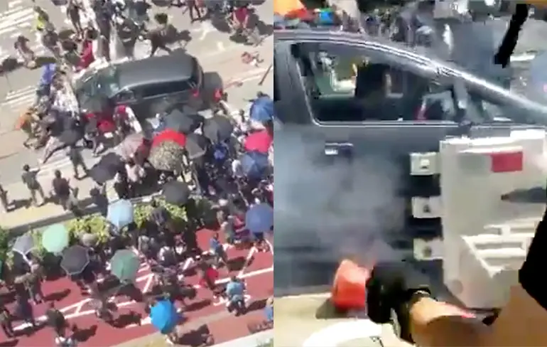 Automobilist in Hong Kong heeft geen boodschap aan geblokkeerde weg
