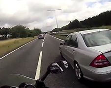Idiote motorrijder probeert sandwich met 2 vrachtwagens