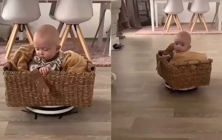 Koop uw penningen aan de kassa: Baby vermaakt zich op robotstofzuiger