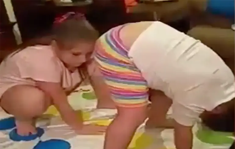 Meisje laat een vliegen om spelletje Twister te winnen