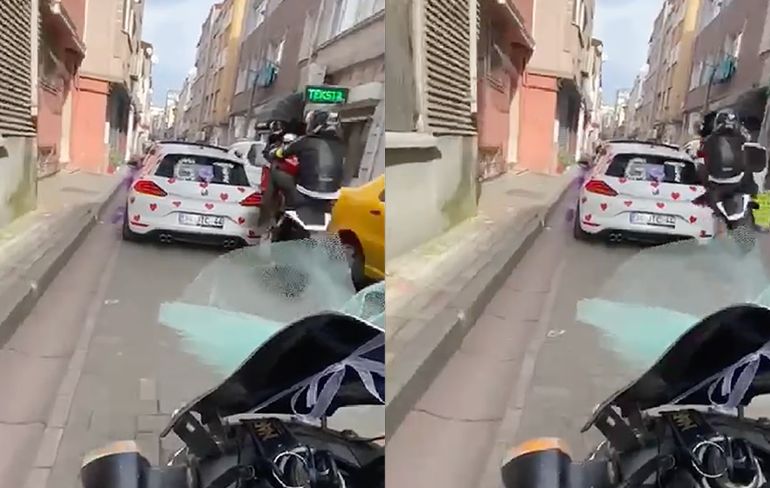Motorrijder doet een wheelie in een te druk en smal straatje... Gaat dus FOUT!