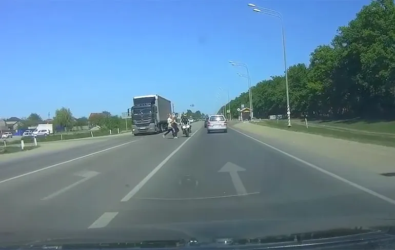 Motorrijder ontwijkt voetgangers, maar geeft tegenliggende auto wel een kus
