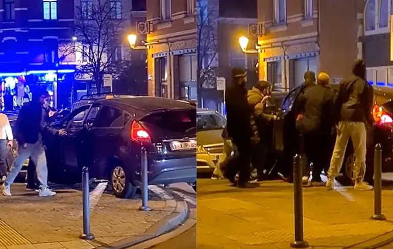 Omstanders proberen auto na ongelukje weer op de weg te duwen