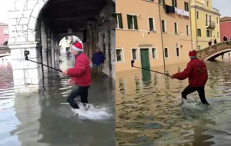 Toerist met selfie-stick haalt nat pak in overstroomd Venetië