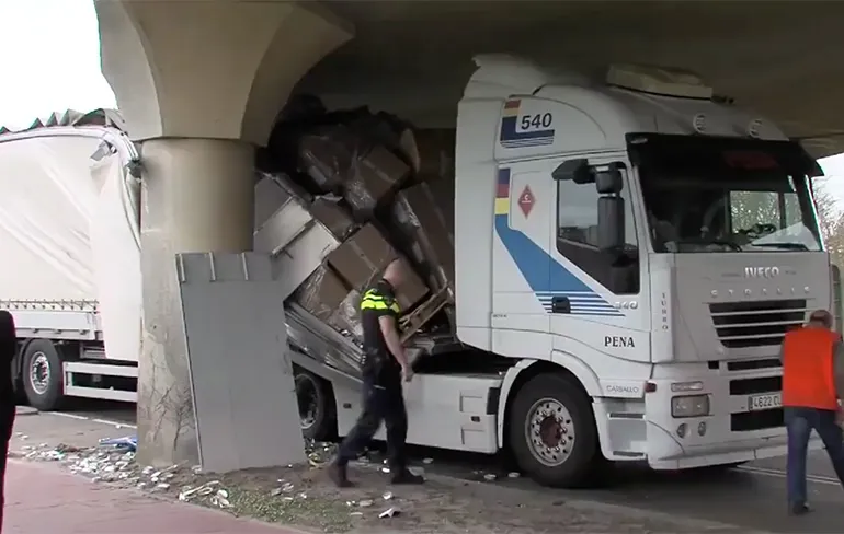 Vrachtwagen scheurt open onder viaduct Harlingen