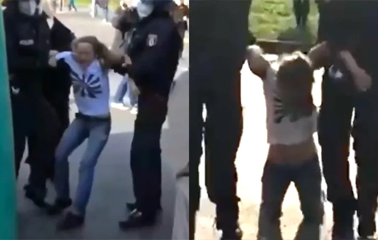 Vrouwelijke demonstrant komt niet helemaal lekker uit politiebusje in Berlijn...