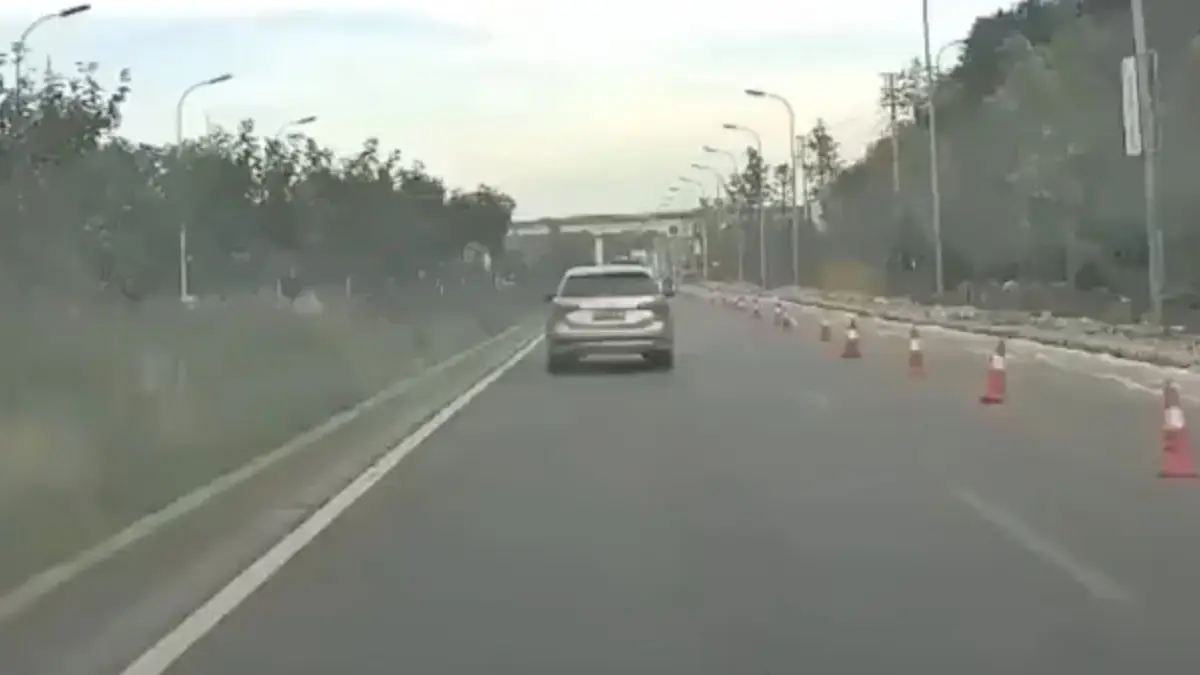 Moeder van het jaar laat kleine uit rijdende auto kruipen