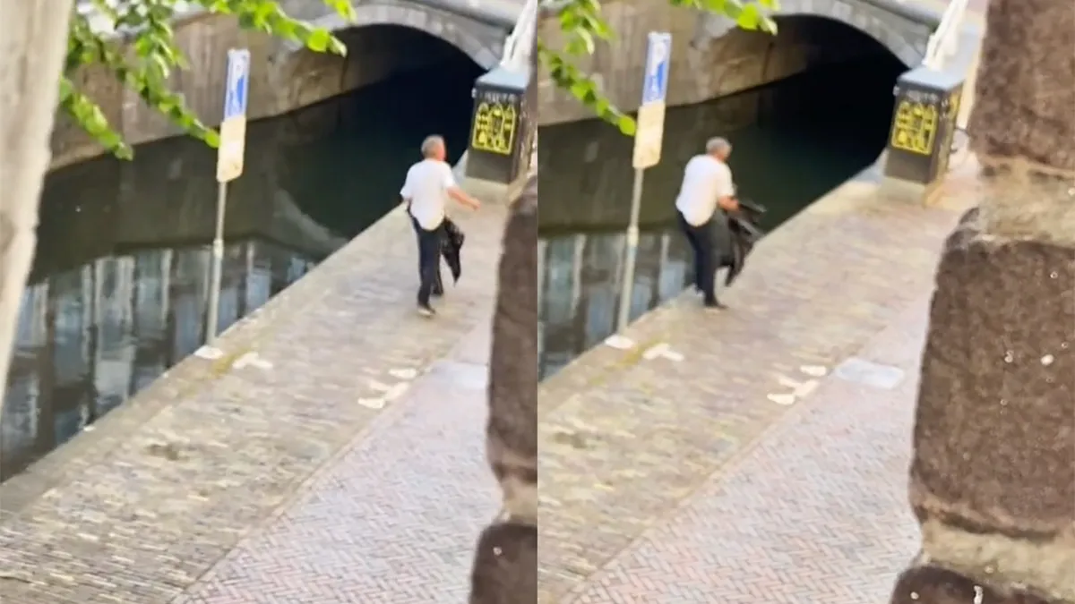 Man is boos, maar kan niet zijn evenwicht houden, dus hoppa de gracht in