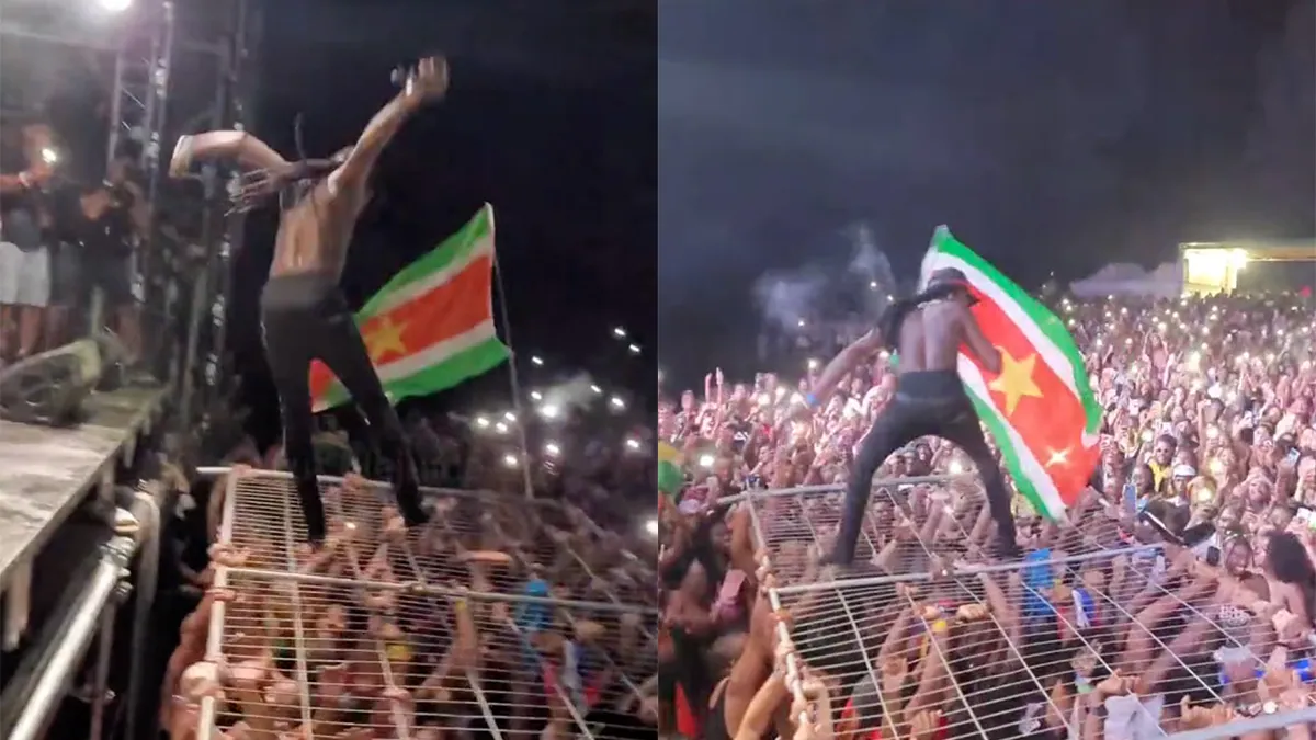 Mr. Killa doet aan crowdsurfing op een hek op festival in Parijs