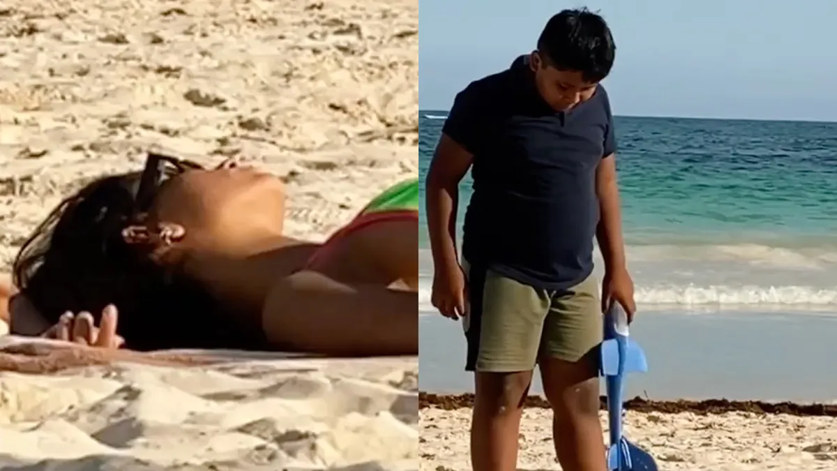 Ongegeneerd Jochie op het strand geeft zijn ogen even goed de kost
