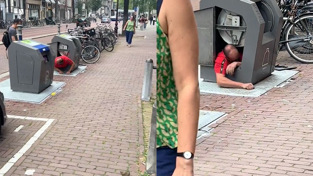 Man in Amsterdam klimt in vuilcontainer