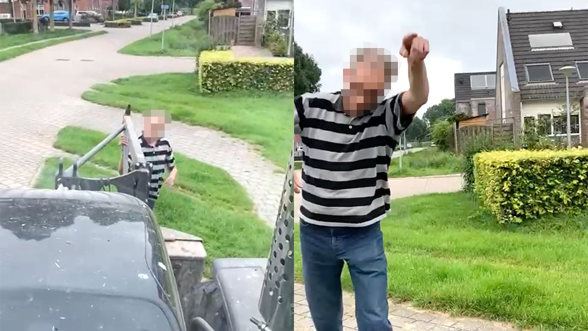 Boze man probeert tegen te houden dat er gras wordt gemaaid
