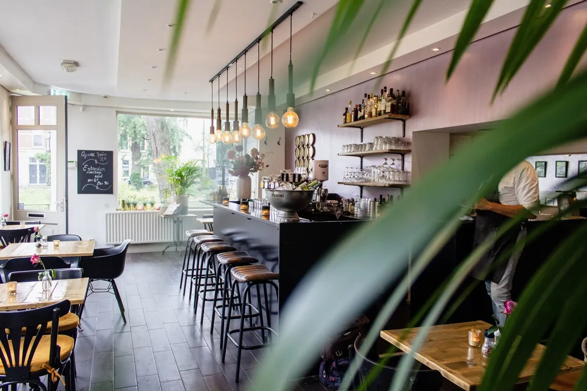 interior shot cafe with chairs near bar with wooden tables 181624 1669