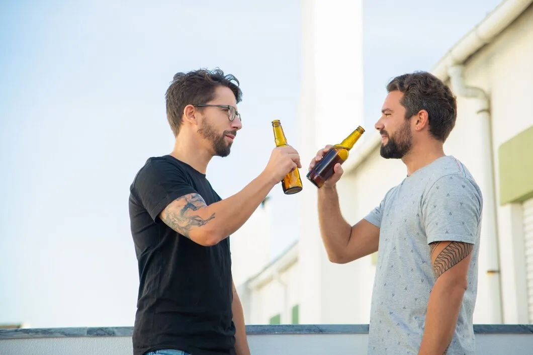 two male friends sharing good news drinking beer 74855 2682