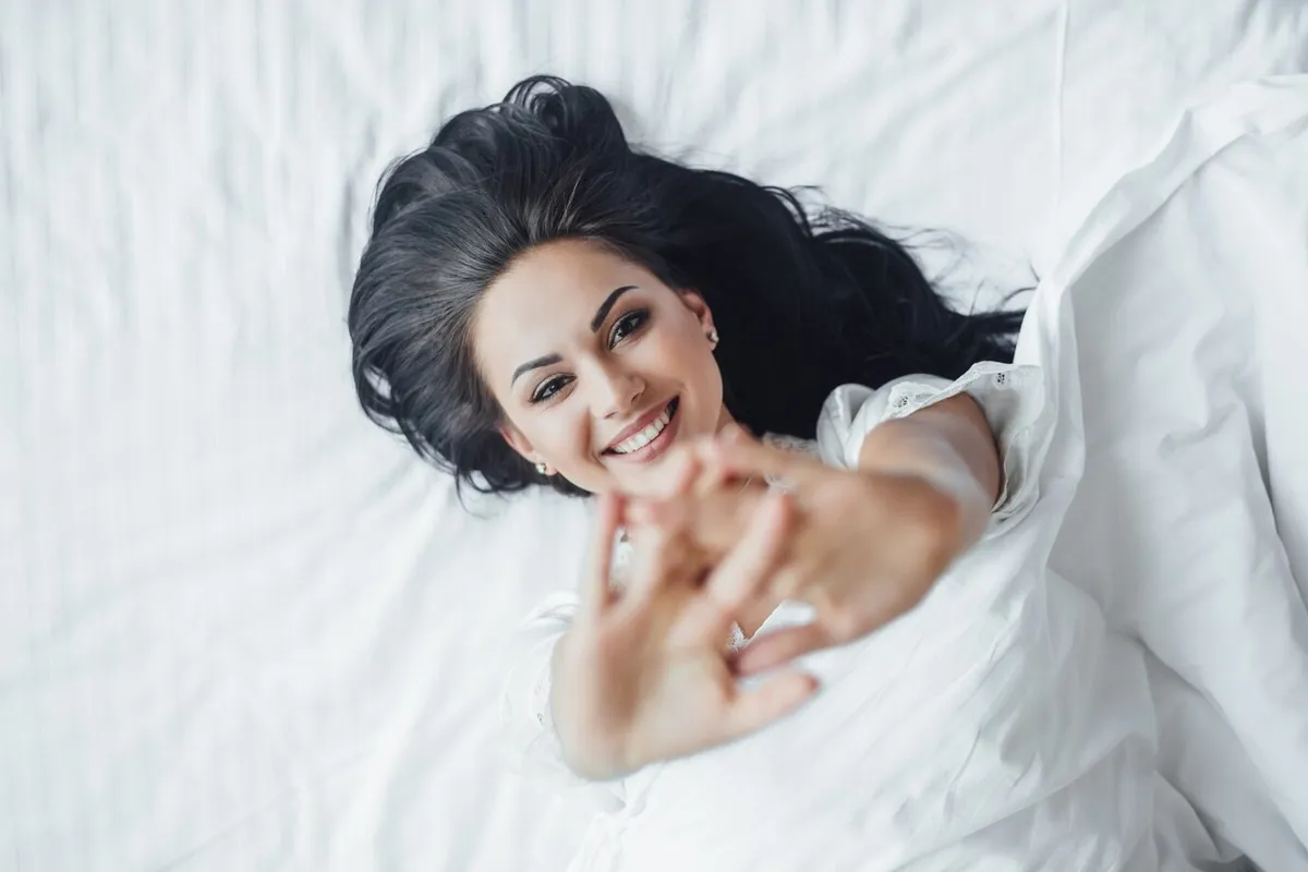 young beautiful brunette happy girl lies her bed waking up morning sweating top view 496169 2304