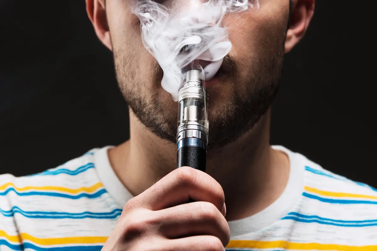 face vaping young man