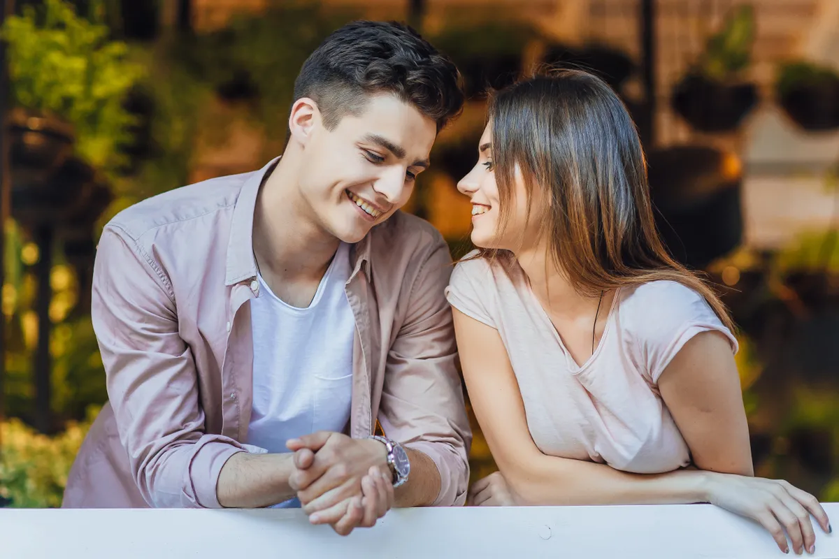 young beautiful couple talking terrace restaurant casual clothes