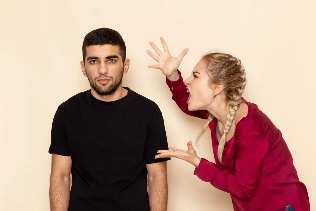 front view young female red shirt quarelling with male cream space female cloth photo violence 140725 28655
