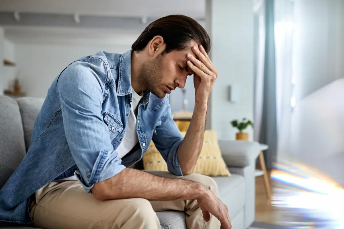 young man having headache holding his head pain home 637285 5905 64d0c05212e3f