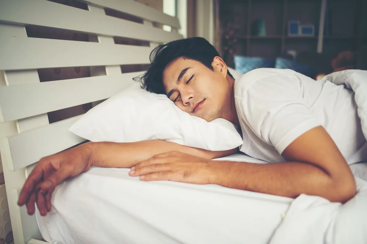 man sleeping bed morning