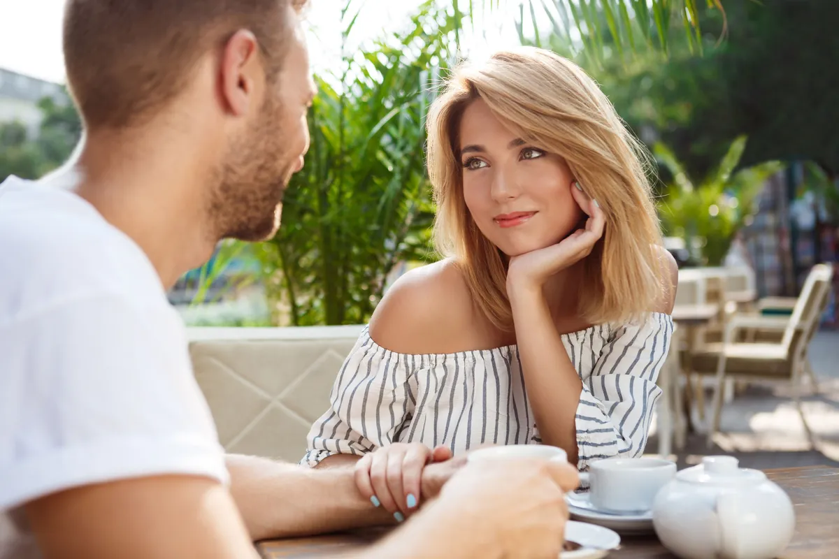 young beautiful couple speaking smiling resting cafe
