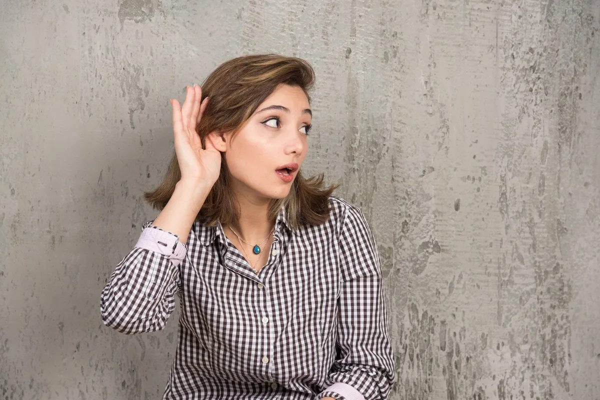 teenager girl listening something by putting hand ear 114579 58475