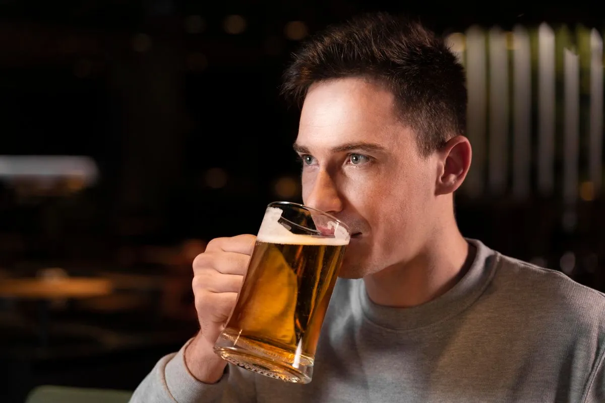 close up man drinking beer from mug 647b8e23426f3