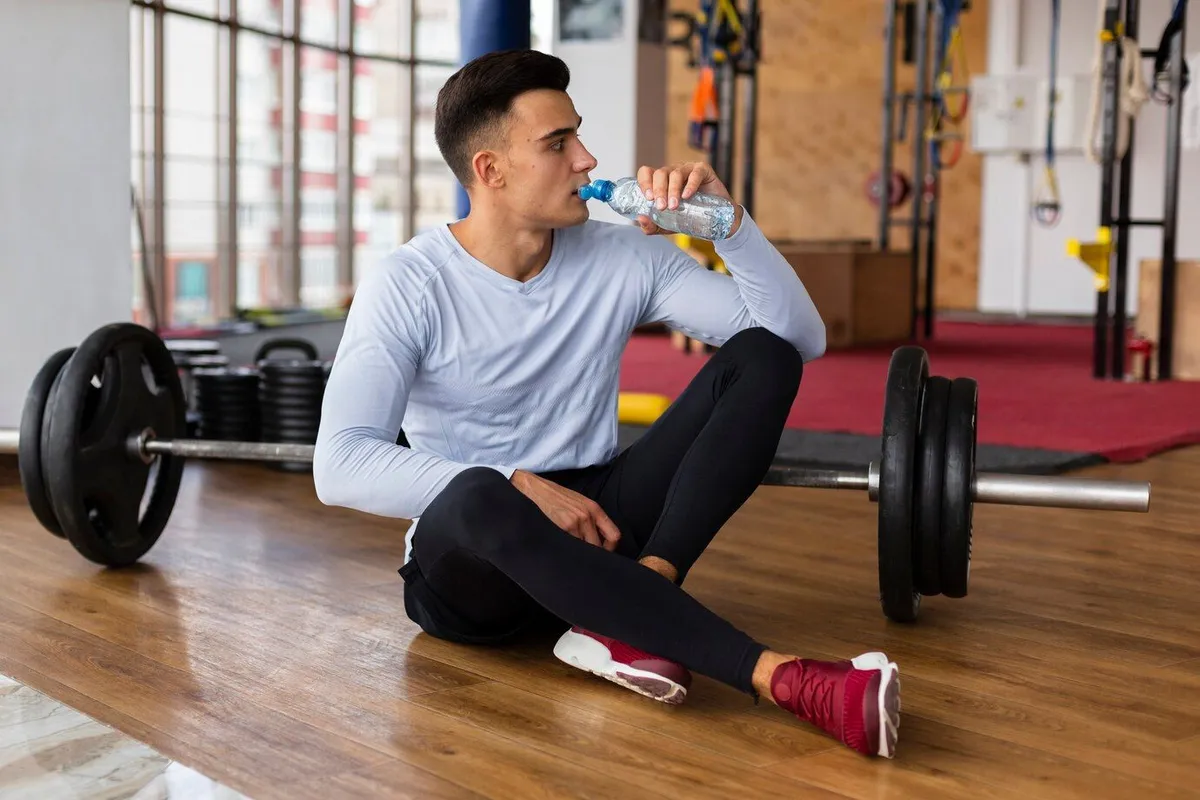 young man hydration break after exercises 23 2148284950