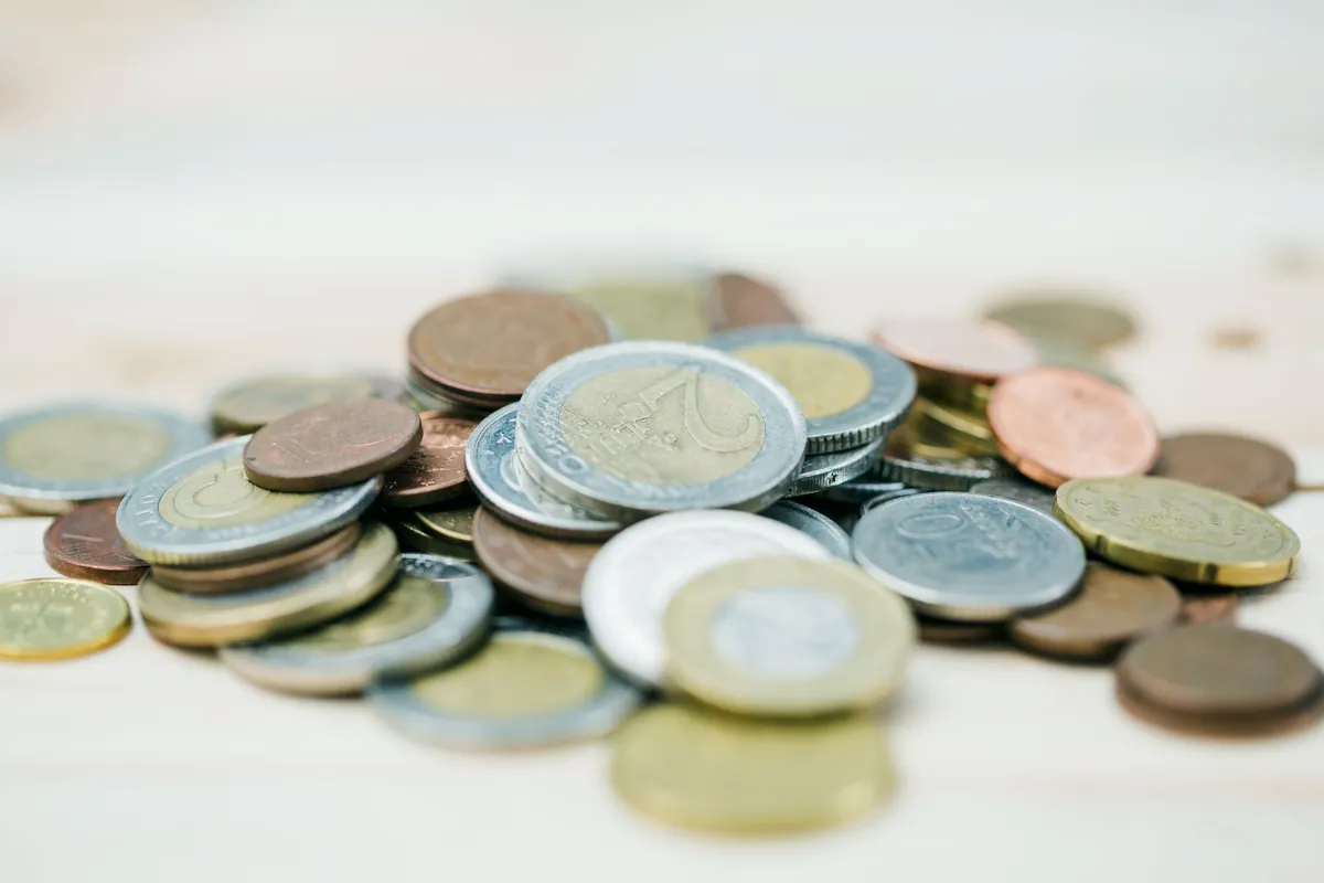 spread metallic coins defocused background