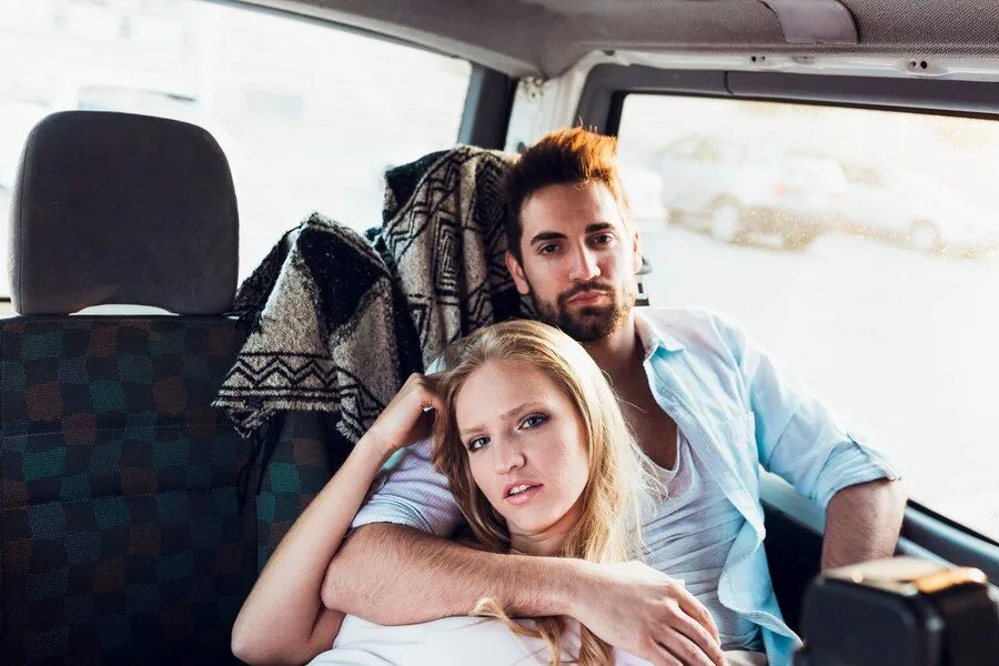 young couple backseat car 23 2147817970
