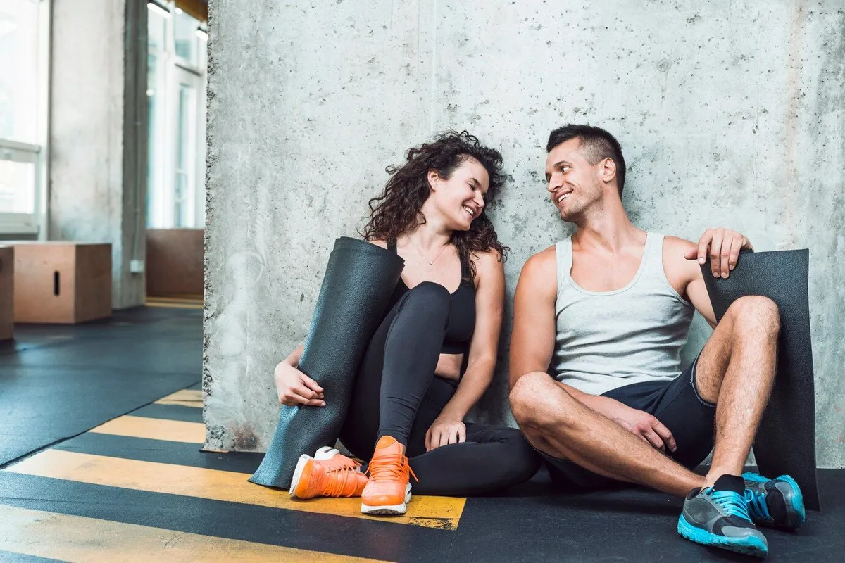 happy man women with exercise mat sitting gym 23 2147949673