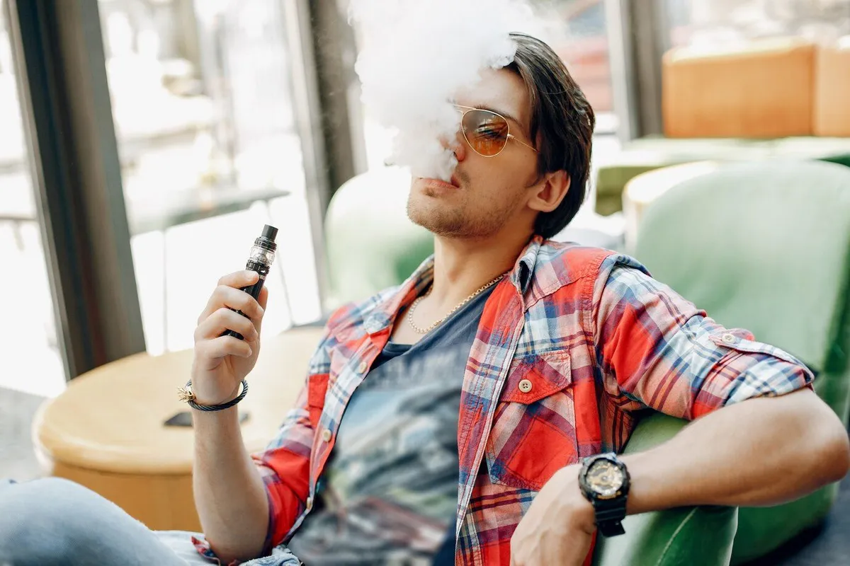 stylish elegant man sitting cafe with vape 1157 34784