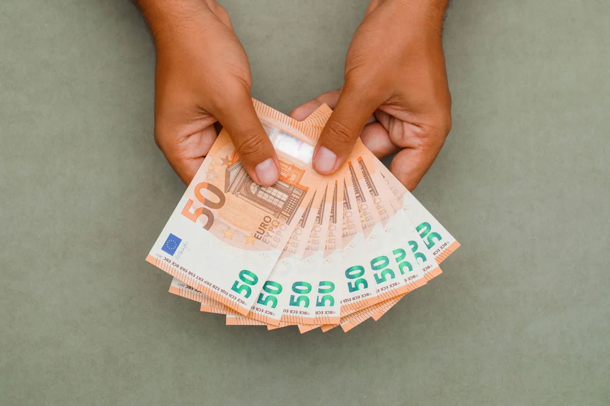 businessman holding euro bills