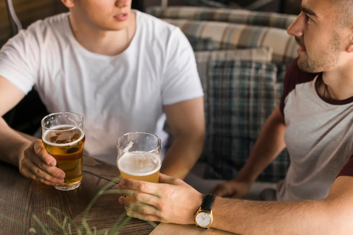 overhead view young male friends holding glass beers 23 2147859532