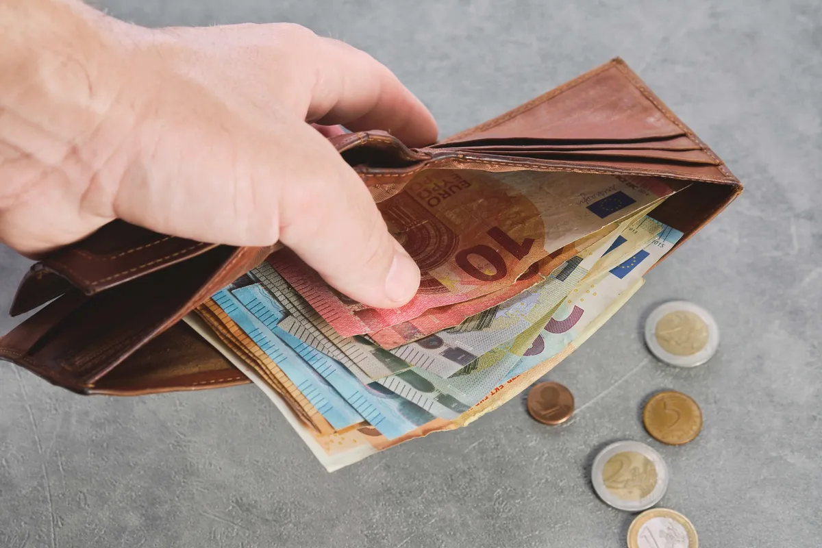 senior man holds wallet with euro banknotes his hand euro banknotes wallet wallet with money man s hand background idea paying taxes buying paying services 1