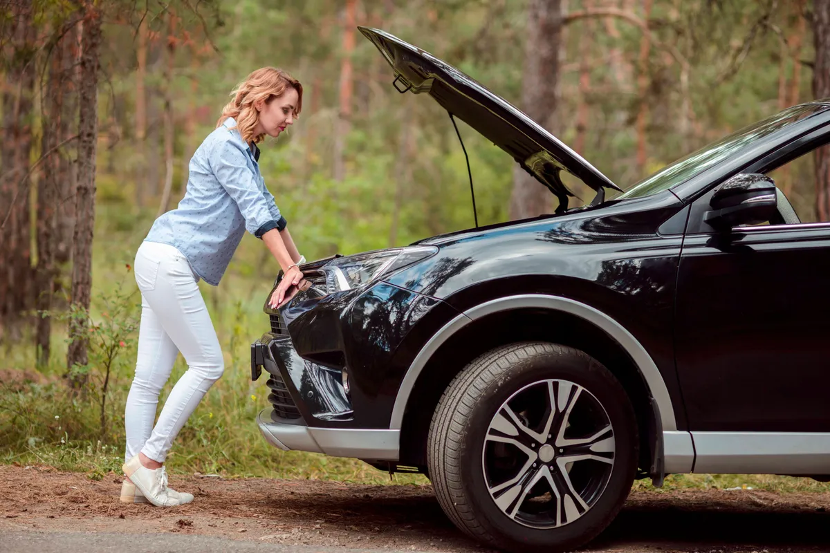 full shot woman checking car