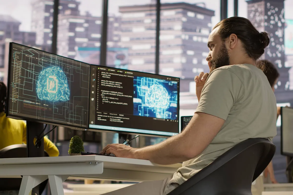 man monitoring maintaining artificial intelligence company systems