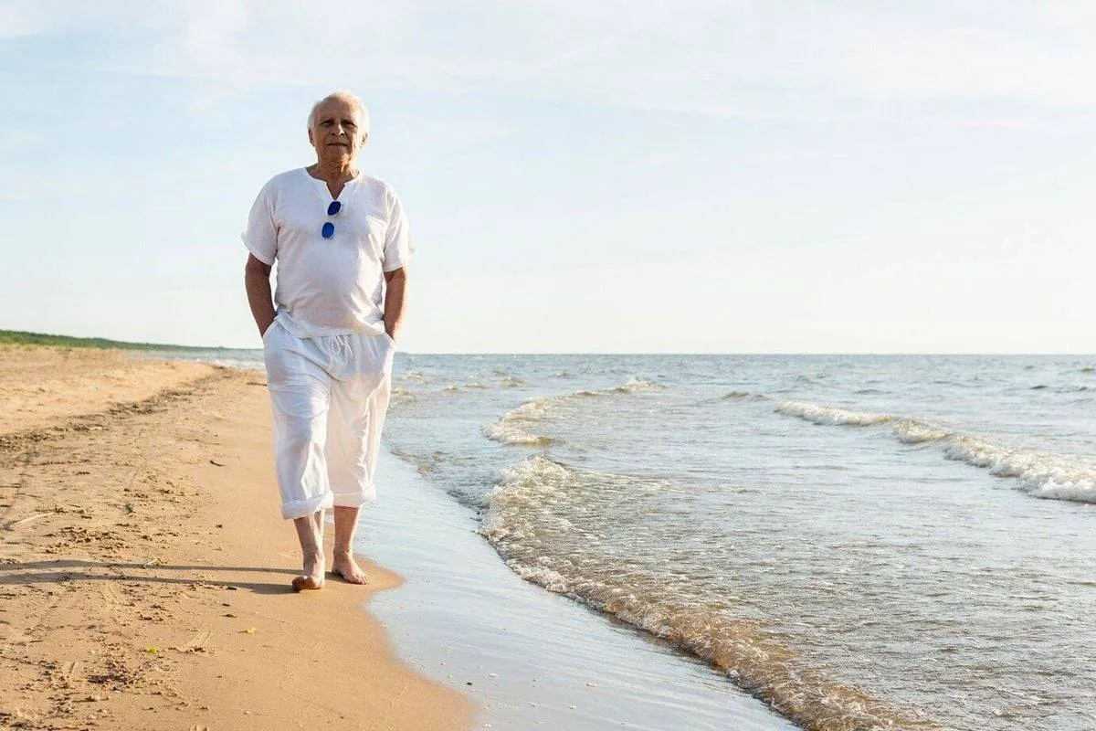 older man walking by beach enjoying view 23 2148641926 658d8f350ba94