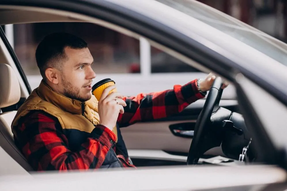 portrait handsome man sitting car drinking coffee 1303 21830