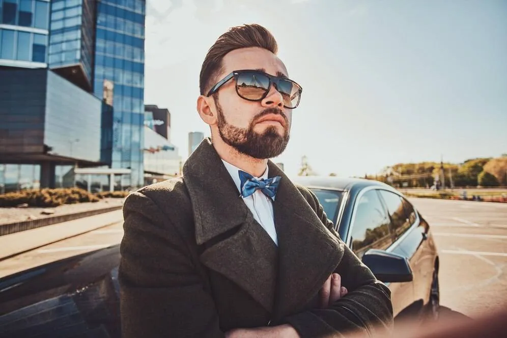 smart groomed man coat is standing near his new car 613910 21513