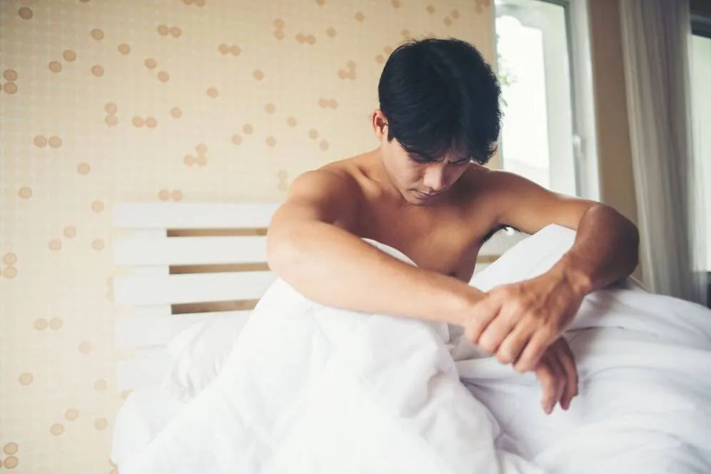 worried man sitting bed morning serious thinking something 1150 5039