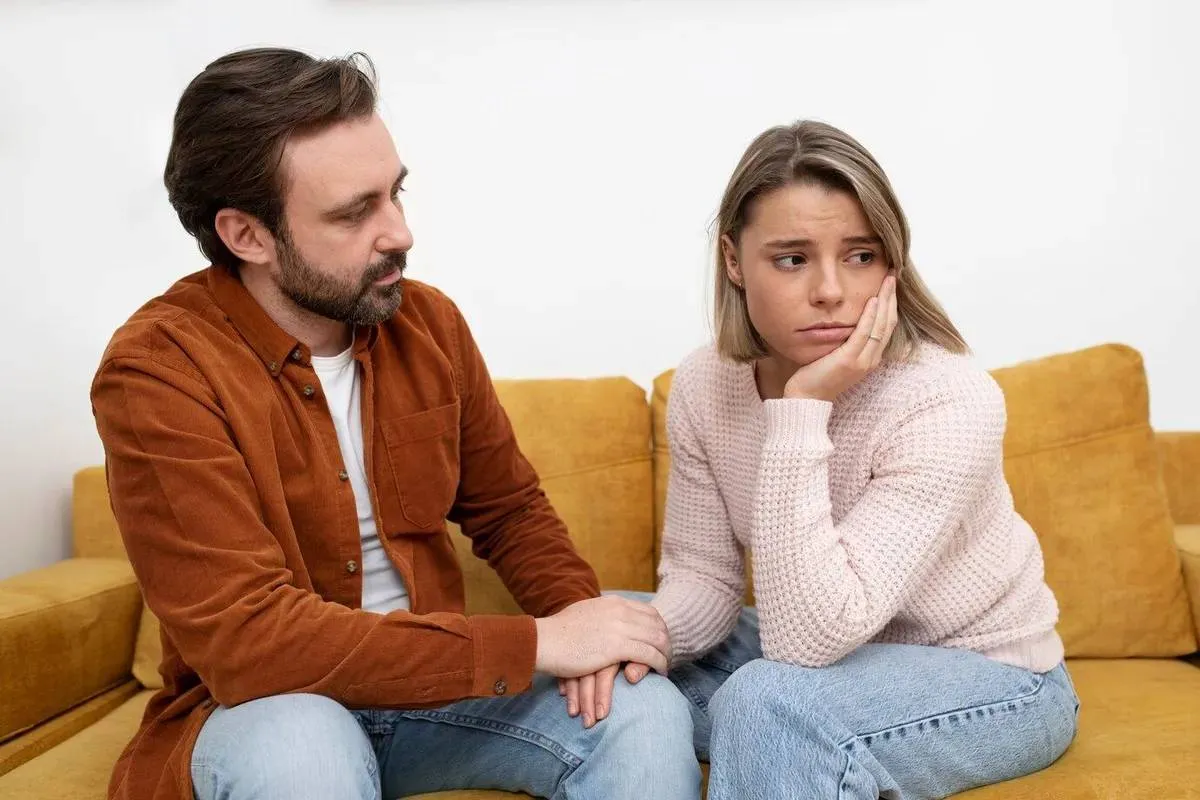 medium-shot-sad-couple-couch-23-2149308842-666866bea5449