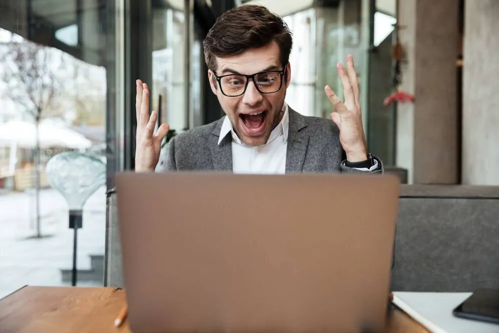 shocked-screaming-businessman-eyeglasses-sitting-by-table-cafe-rejoice-while-looking-laptop-computer-171337-5568-67dd164e12378