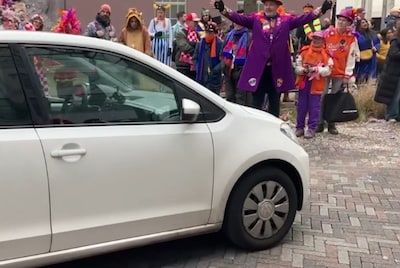 Bijzondere deelnemer aan de carnavalsoptocht in Eindhoven, automobilist rijdt kort stukje over de route