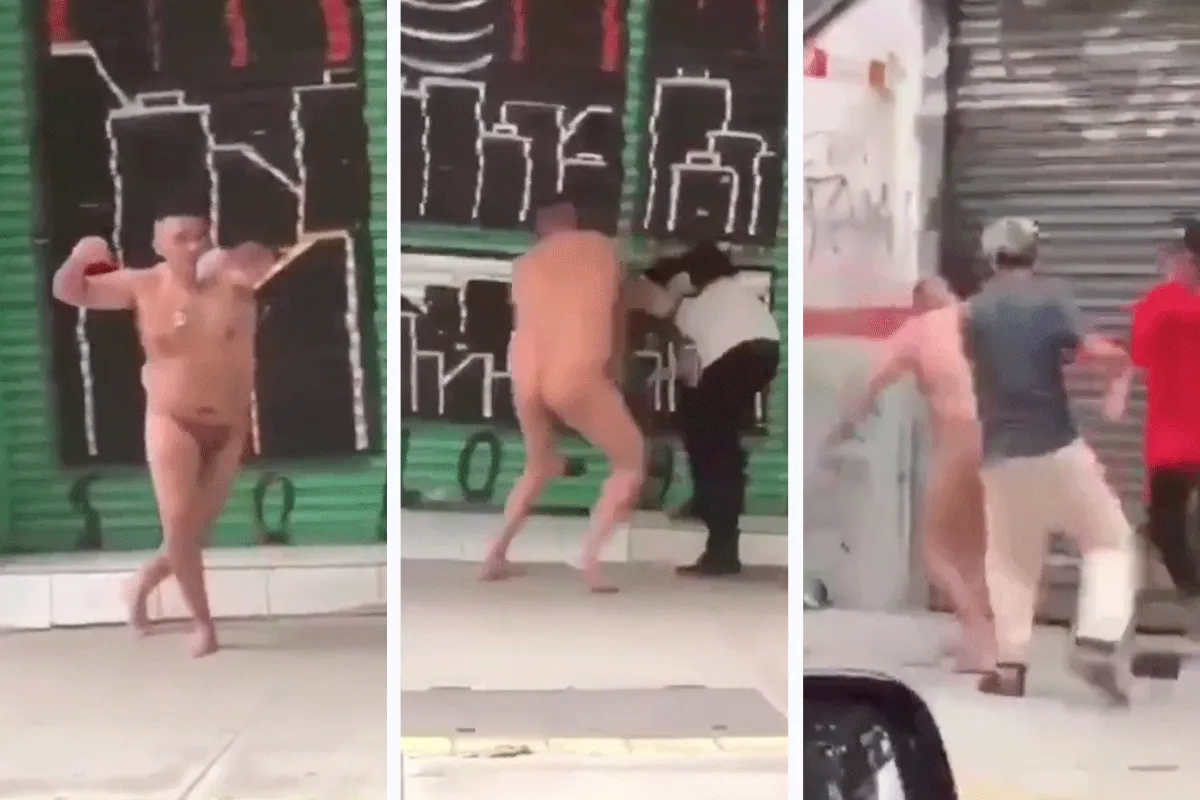 Agressieve naakte 'GEK' krijgt klappen op straat (video)