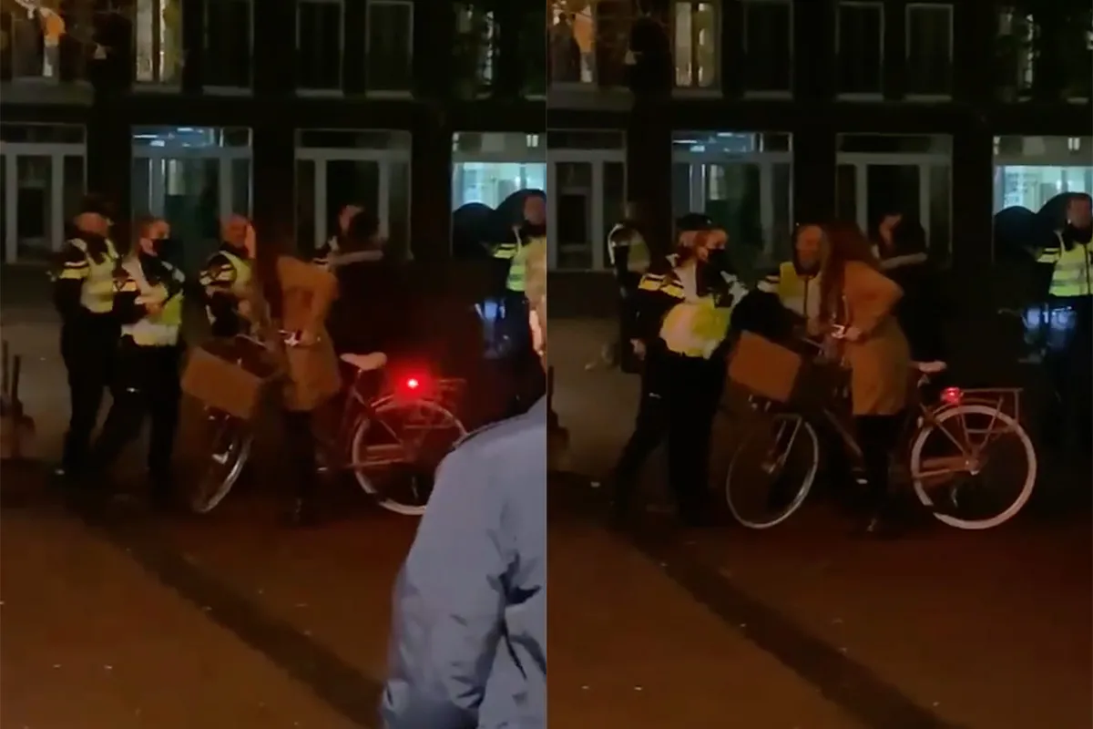 Vrouw op fiets krijgt boodschap om weg te gaan, maar ze gaat niet weg