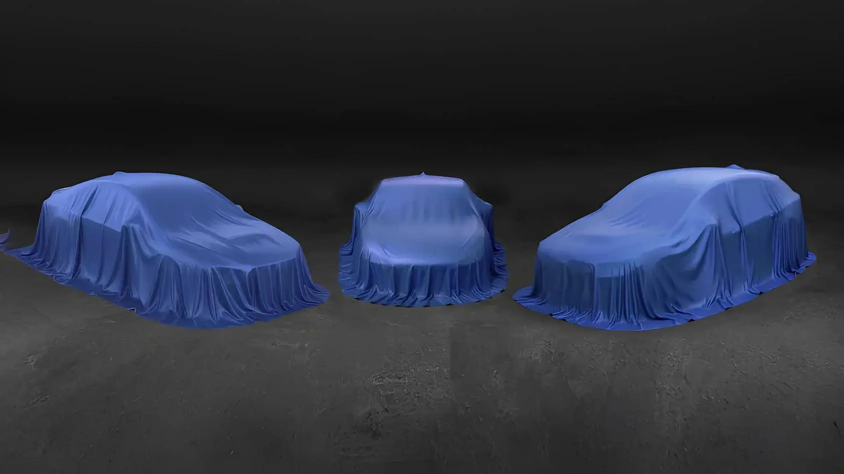 Nell'immagine si vedono tre auto coperte di Subaru